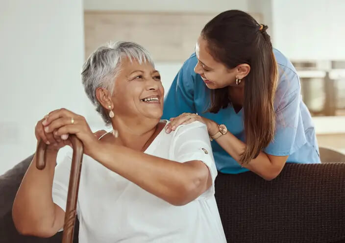 Senior woman with caregiver smile while at the Gables at Spring Lake Assisted Living Home