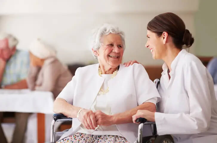 An elderly woman talking with her nurse in Spring Lake nursing home