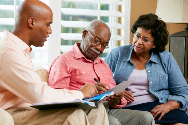 Son discussing nursing home information with elderly parents in Spring Lake