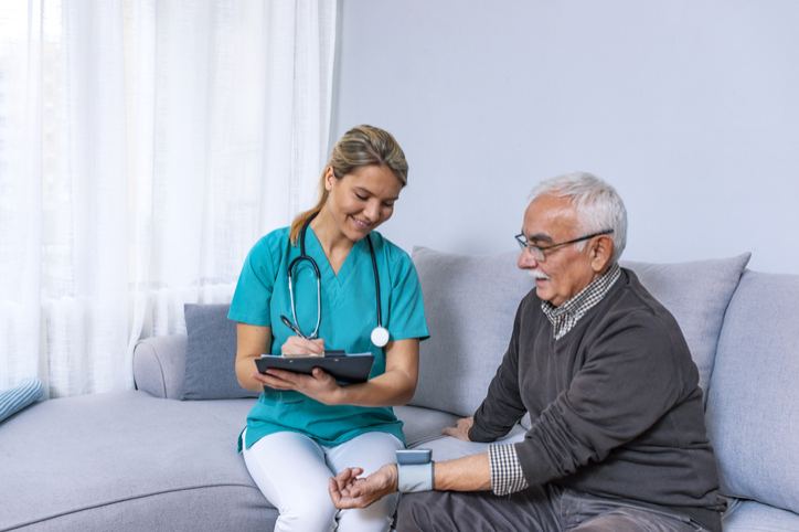A Man receives Attentive Care from a Female Nurse at The Gables Assisted Living in Spring Lake.
