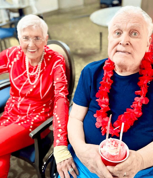 An older couple is seated in the chair enjoying an Assisted Living Activity in Spring Lake