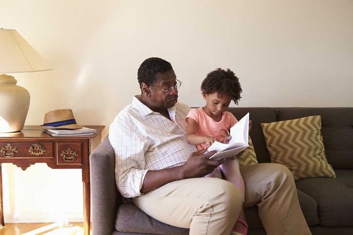 Grandchild visiting grandfather at assisted living facility