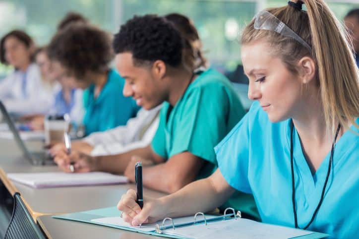 Group of nurses writing notes